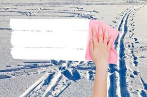 hand deletes winter snow field by pink rag photo