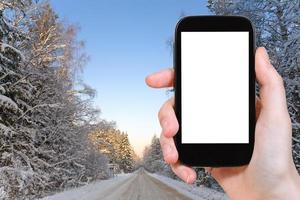 photo of winter road in snowy russian forest