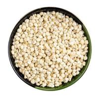 polished Sorghum groats in round bowl isolated photo