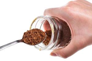 glass jar with soluble coffee and spoon isolated photo