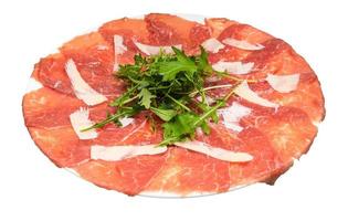 served Carpaccio dish on white plate isolated photo