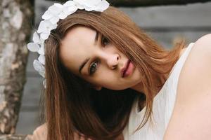 Lovely girl near a wooden house photo