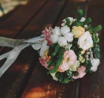 Wedding bouquet on a bench photo