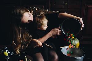 mother and daughter playing together at home photo