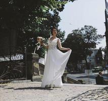 Bride posing in city photo