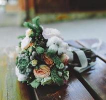 Wedding bouquet on a bench photo