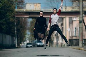 Beautiful young couple jumping photo
