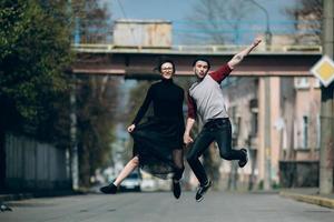 Beautiful young couple jumping photo