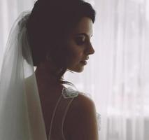 Bride posing in a large window photo