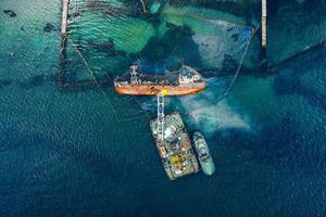 Top view of an old tanker that ran aground and overturned photo