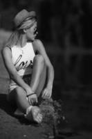 beautiful girl sitting on the pier photo