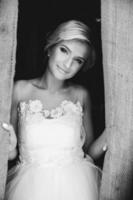 Smiling beautiful bride in doorway photo