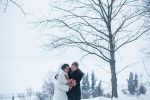 Bride and groom walking on the European city in the snow photo