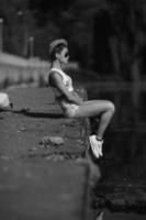 beautiful girl sitting on the pier photo