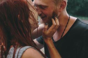 beautiful couple hugging in the rain photo