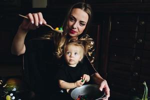 mother and daughter playing together at home photo