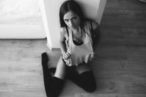 beautiful young girl posing sitting on the floor photo