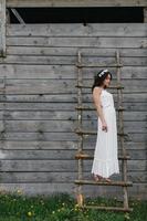 Lovely girl near a wooden house photo