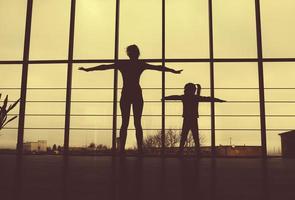 Silhouette of mother and daughter in the gym photo