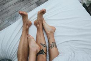 Young adult couple lying on bed photo