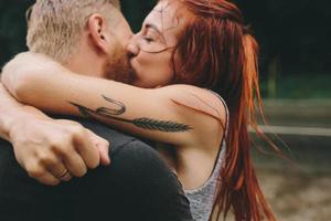 beautiful couple kissing  in the rain photo