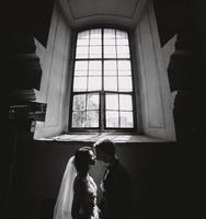 bride and groom on the background of a window. photo