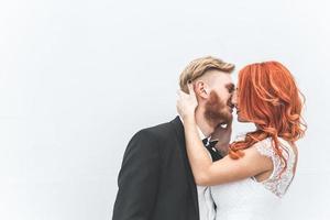 Wedding couple on a background of whitewall photo