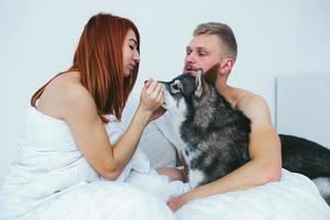 Young adult couple lying on bed photo