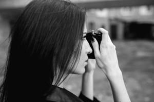 Beautiful female photographer posing with camera photo