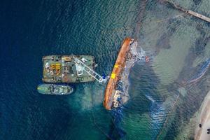 Top view of an old tanker that ran aground and overturned photo