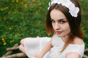 Lovely girl near a wooden house photo