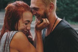 beautiful couple hugging in the rain photo