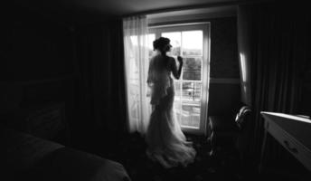 bride looking through the window photo