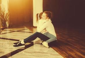 Mother and daughter hugging in the gym photo