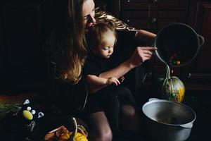 mother and daughter playing together at home photo