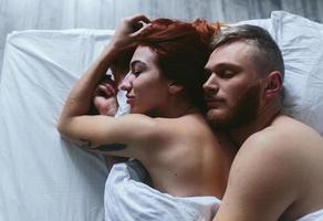 Young couple in bed together photo