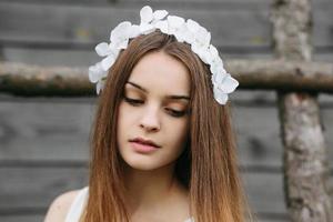 Lovely girl near a wooden house photo