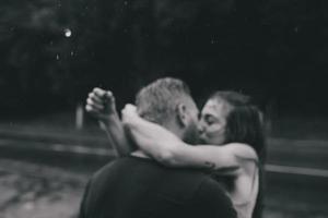 beautiful couple kissing  in the rain photo