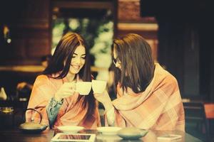 Two young and beautiful girls gossiping photo