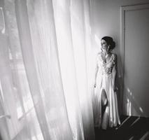 Bride posing in a large window photo