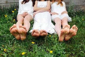 Three charming girls  near a wooden house photo