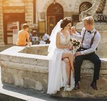 Bride and groom posing at the fountain photo