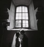 bride and groom on the background of a window. photo