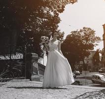 Bride posing in city photo