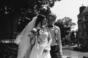 bride and groom posing on the streets photo