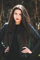 Glamorous young woman in black leather jacket photo