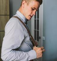 groom in the morning getting ready photo