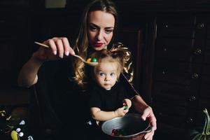 mother and daughter playing together at home photo