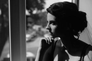 bride looking through the window photo