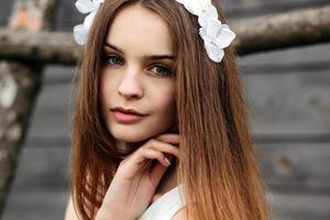 Lovely girl near a wooden house photo